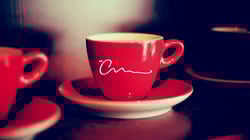 Branding is important. The Creative Momentums logo is featured on a coffee cup