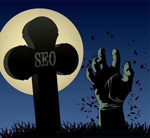 You may need to adjust your SEO strategy. A full moon, “SEO” on a grave and a zombie hand stretching out of the ground.