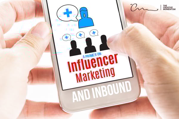 A Primer on Influencer Marketing and Inbound written on a smartphone that is being held close-up.