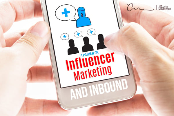 A Primer on Influencer Marketing and Inbound written on a smartphone that is being held close-up.