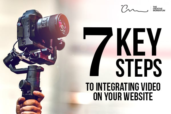 Follow these 7 key steps to integrate video on your website. Hand holds up a video camera.