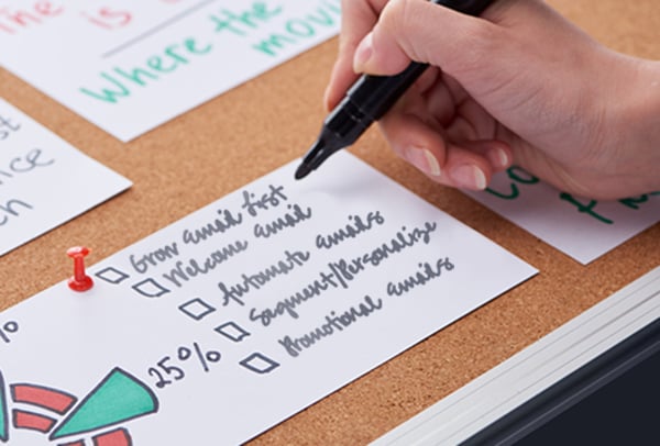 How do you revitalize your email marketing? - hand checking a list of email best practices.