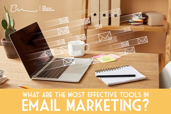 Here's a list of the most effective email marketing tools - laptop on desk with flying envelopes