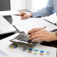 Learn how Google calculates your Google Quality Score so you can improve yours -  person using calculator