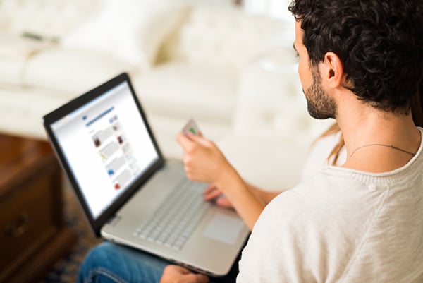 How to Improve Your B2B Web Design - Man next to a woman working on a laptop; both peering at the screen
