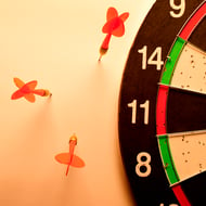 Improve conversions by correcting your ad targeting - Dart board with missed darts