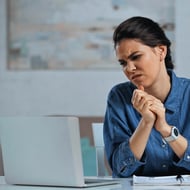 Improve conversions by improving your landing page content and design - Woman not liking what she sees on computer screen