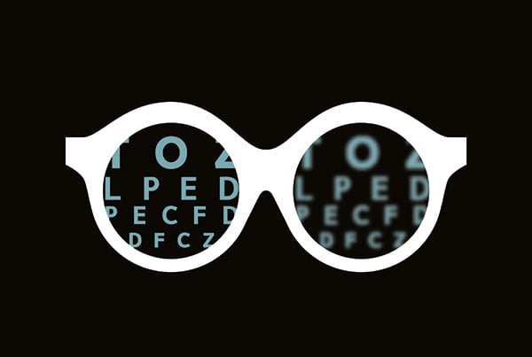 Why website dark mode? It's better for your eyes - Glasses with letters on each lens, one side blurry, the other clear