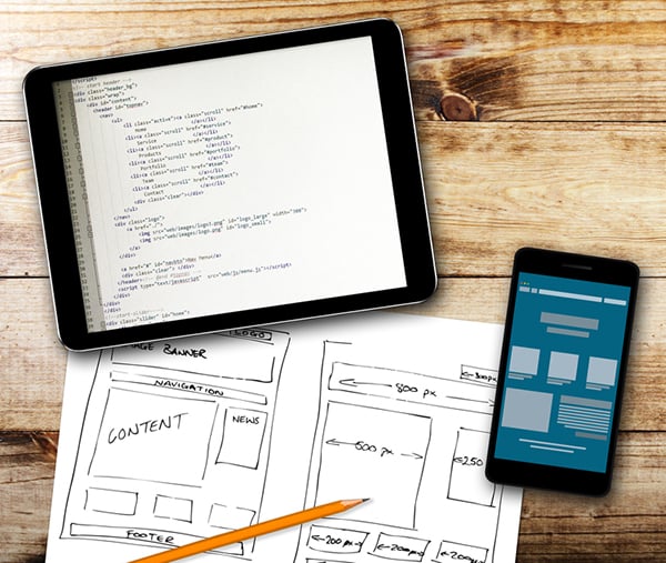 Here are tools to help you with responsive design. Tablet with website design wireframe